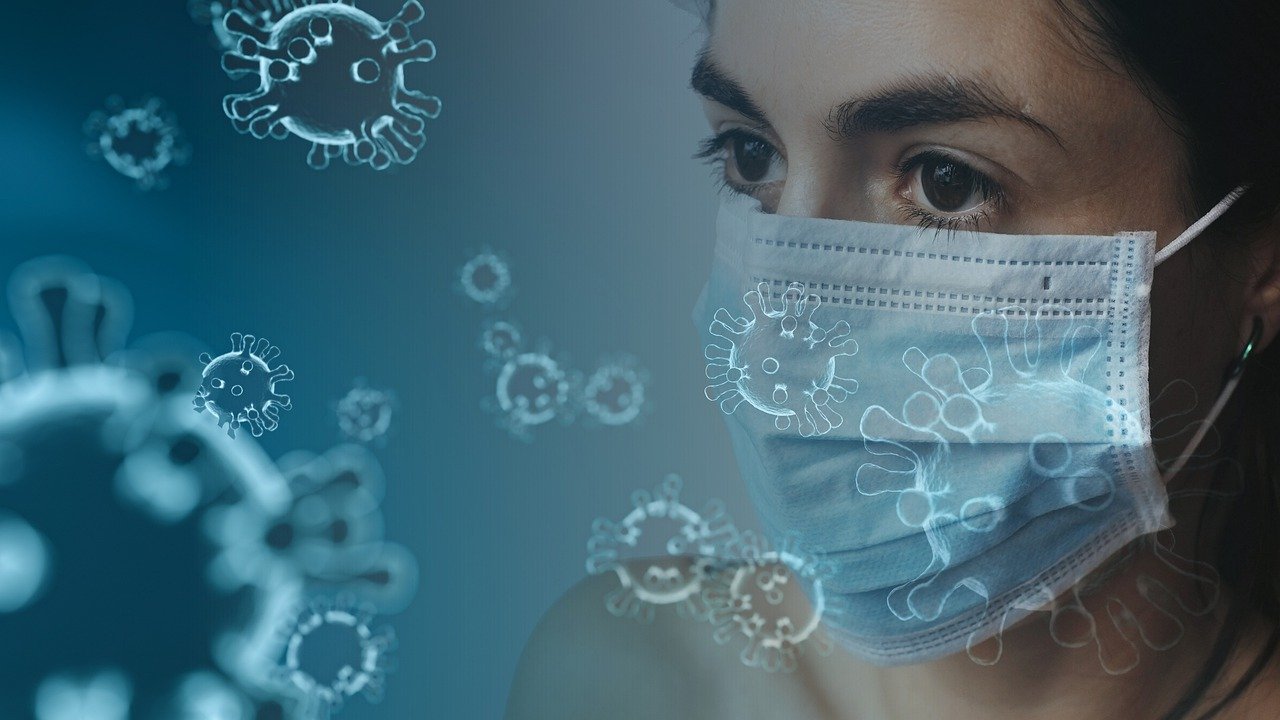 Woman in mask with virus pieces
